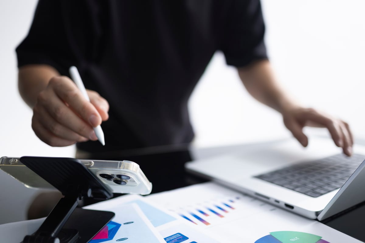 tartup founder reviewing SaaS subscription costs on laptop with charts and reports.